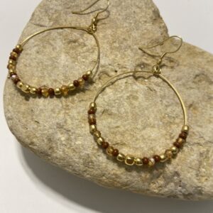 Orecchini a cerchio in oro con perline dai colori vivaci. Design leggero e boho-chic, perfetto per ogni occasione. Disponibile in 5 tonalità.