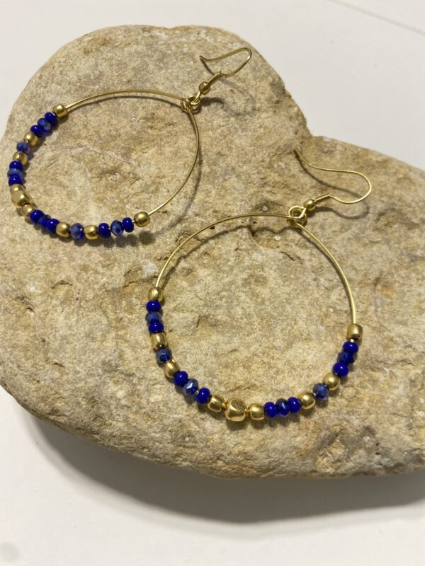 Orecchini a cerchio in oro con perline dai colori vivaci. Design leggero e boho-chic, perfetto per ogni occasione. Disponibile in 5 tonalità.